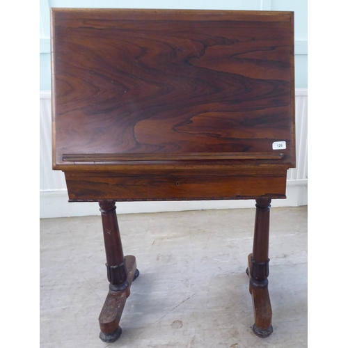 126 - A William IV rosewood reading table with a hinged top, over a height adjustable lectern, on a ratche... 