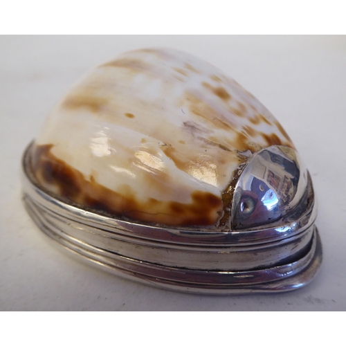 127 - An 18th/19thC cowrie shell and silver mounted snuff box with a flush fitting hinged lid and discrete... 