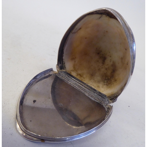 127 - An 18th/19thC cowrie shell and silver mounted snuff box with a flush fitting hinged lid and discrete... 