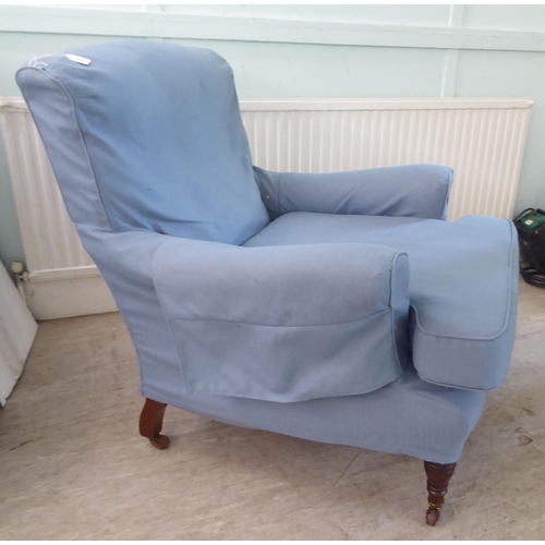 130 - A late Victorian library chair with a level back and enclosed arms, re-upholstered in patterned blue... 