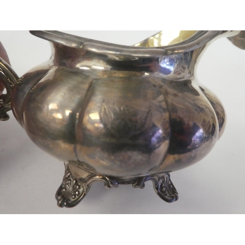 131 - A George IV silver melon shape cream jug with a flared rim on S-scrolled handle, on a shell cast foo... 