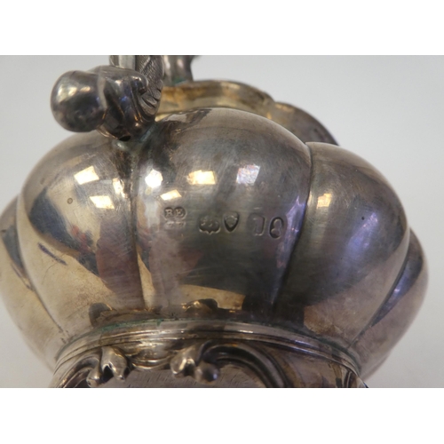 131 - A George IV silver melon shape cream jug with a flared rim on S-scrolled handle, on a shell cast foo... 