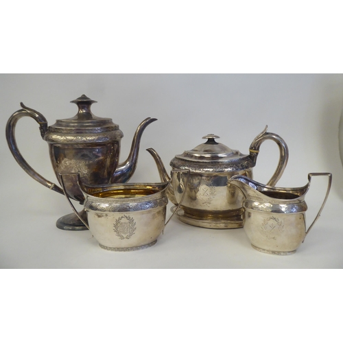 139 - A George III silver five piece tea set of oval form with engraved ornament, including armorials ... 