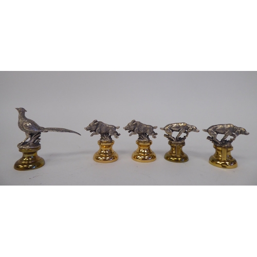 165 - A set of five Holland & Holland silver and gilt coloured metal novelty menu holders, featuring w... 