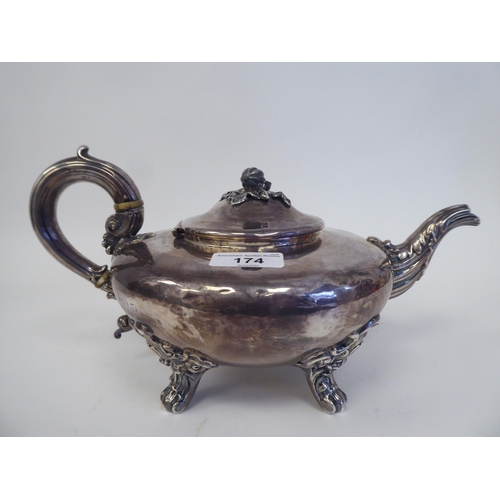 174 - An early 19thC silver teapot of squat, bulbous form with swept spout, a hinged lid, fruit finial and... 