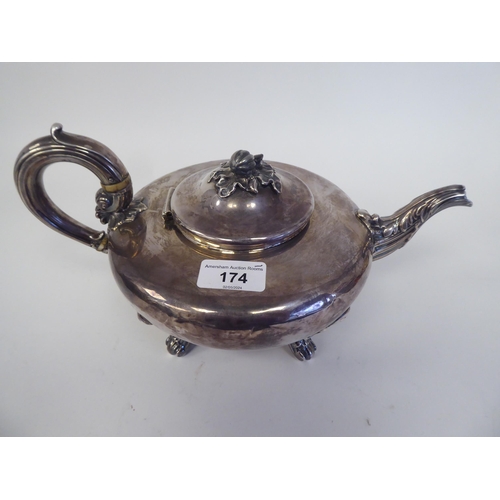 174 - An early 19thC silver teapot of squat, bulbous form with swept spout, a hinged lid, fruit finial and... 