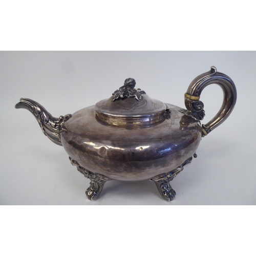 174 - An early 19thC silver teapot of squat, bulbous form with swept spout, a hinged lid, fruit finial and... 