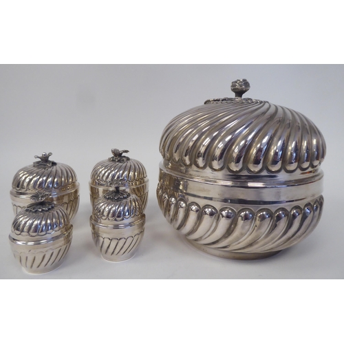 180 - A matched set of silver coloured metal tableware with embossed, swirling, demi-reeded ornament  comp... 