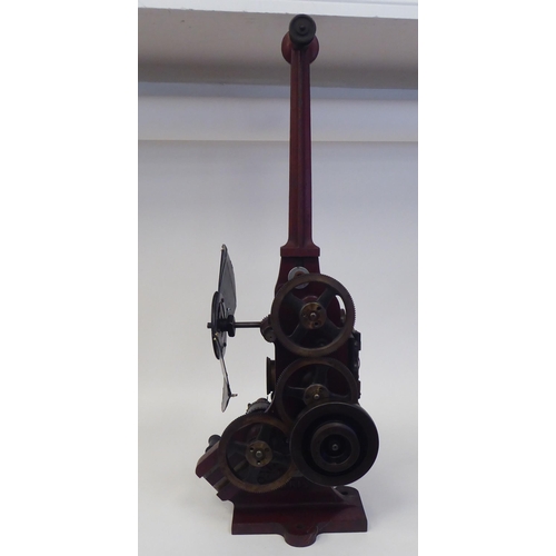 185 - A Pathe Freres, Paris, circa 1906 maroon painted iron, hand crank projector  No.4582, on a plinth  2... 