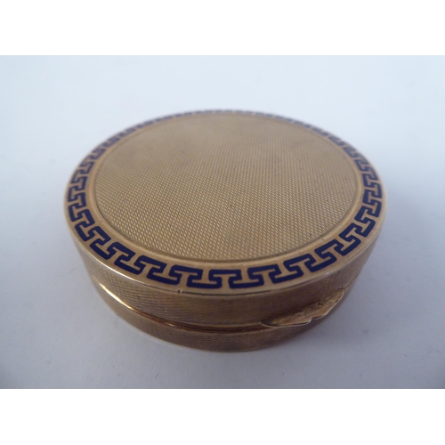 190 - A 9ct gold engine turned and blue enamel, circular powder compact with a hinged lid and inset vanity... 