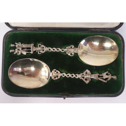 61 - A pair of late Victorian silver gilt presentation anointing style spoons with decoratively cast figu... 