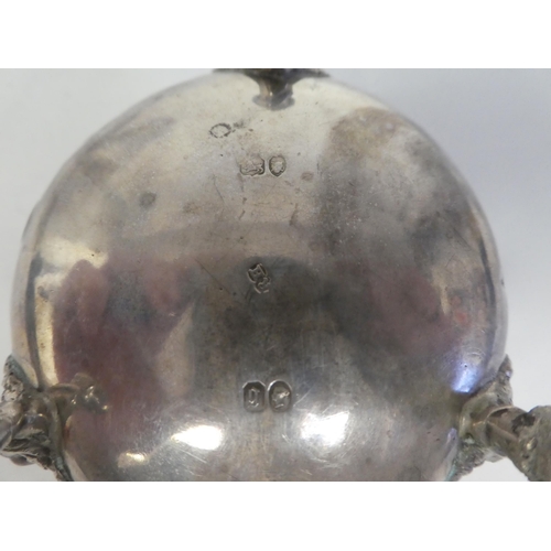 64 - A pair of early Victorian silver shallow, bulbous salt cellars with embossed floral decoration, elev... 