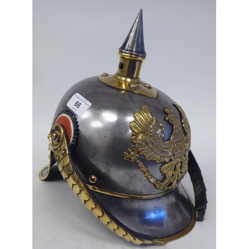 66 - A German Great War spiked, polished steel and brass cavalry helmet with a hide liner and chinstrap(P... 