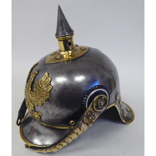 66 - A German Great War spiked, polished steel and brass cavalry helmet with a hide liner and chinstrap(P... 