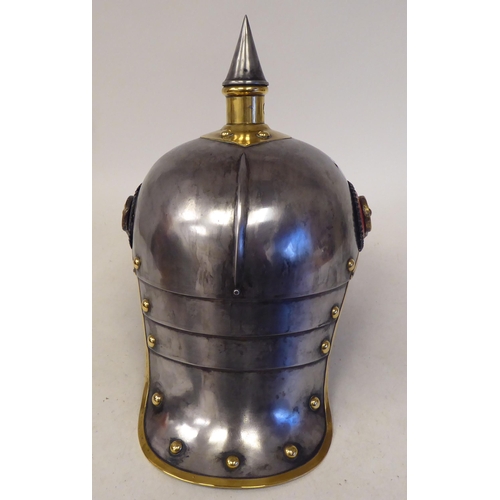 66 - A German Great War spiked, polished steel and brass cavalry helmet with a hide liner and chinstrap(P... 