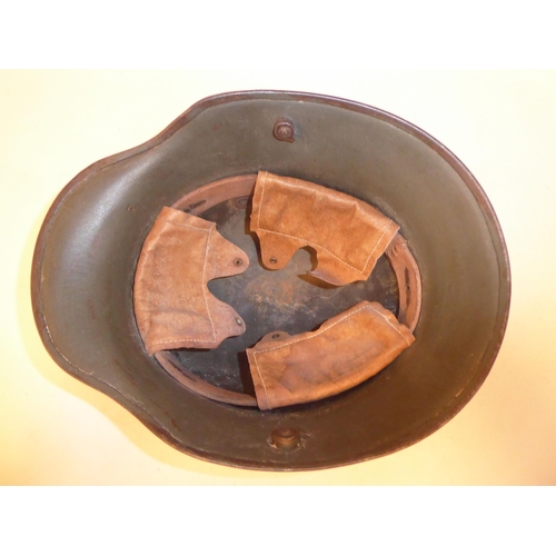 79 - A German Great War military, steel helmet used by the SS in World War II with a hide liner and two d... 