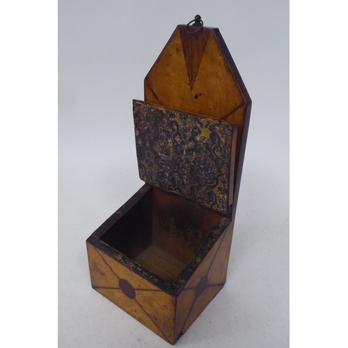 80 - An early 19thC treen satinwood wall hanging salt box with an extended backplate, over an angled hing... 