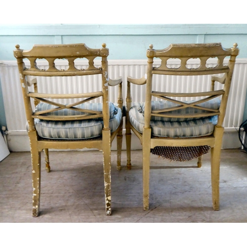 83 - A pair of early 20thC Regency inspired, cream painted and gilded elbow chairs with low, curved backs... 