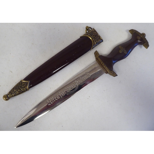 89 - A German Army Stormtrooper presentation dagger with gilded emblems and mounts and a waisted handgrip... 