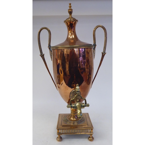 92 - A mid 19thC neo classically styled copper pedestal samovar of twin handled, ovoid form with a cover,... 