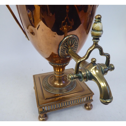 92 - A mid 19thC neo classically styled copper pedestal samovar of twin handled, ovoid form with a cover,... 