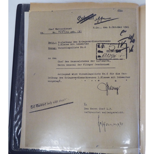 96 - A German World War II era SS flag; and an album of miscellaneous German military orders/documents(Pl... 