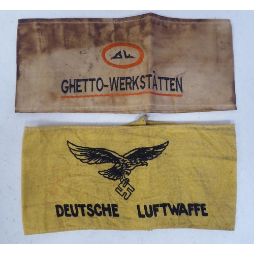 99 - A German World War II era Luftwaffe printed armband; and another, embroidered Ghetto-Werkstatten(Ple... 