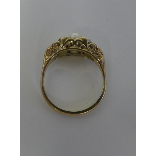 100 - A gold coloured metal ring with a scrolled shank, rubover set with two diamonds and a single pearl  ... 