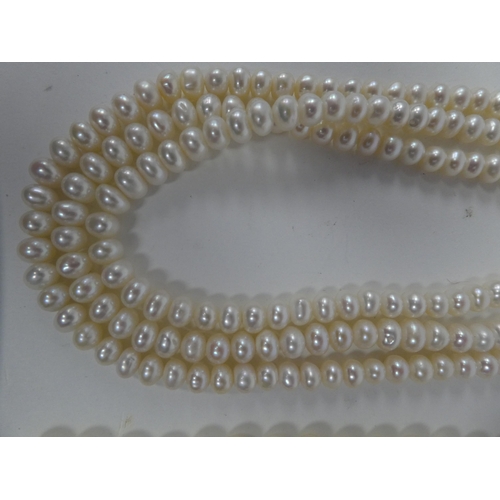 103 - A triple string pearl necklace; and another single strand example, both on 9ct gold clasps