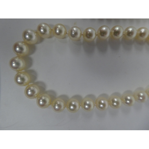 103 - A triple string pearl necklace; and another single strand example, both on 9ct gold clasps