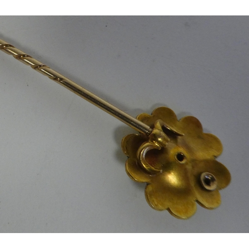 11 - A yellow metal pin brooch, the enamelled flowerhead finial set with diamonds