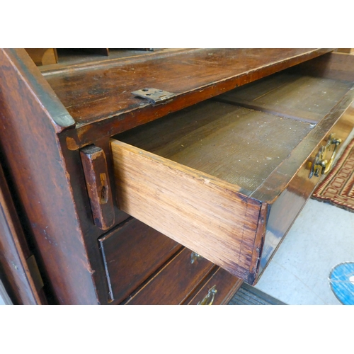 117 - A George III mahogany bureau, the fall flap, over four graduated drawers, raised on turned feet  42