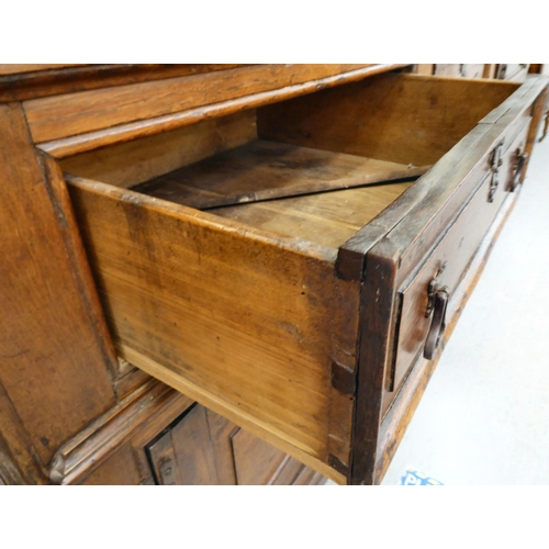 119 - A late 18th/early 19thC stained oak dresser, the superstructure with three open plate racks, the bas... 