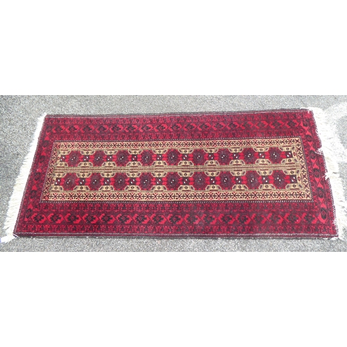 222 - Four dissimilar rugs: to include a Turkoman, on a red ground  34