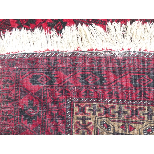 222 - Four dissimilar rugs: to include a Turkoman, on a red ground  34