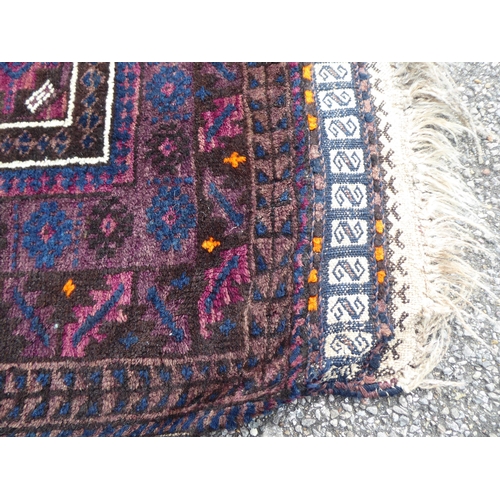 222 - Four dissimilar rugs: to include a Turkoman, on a red ground  34