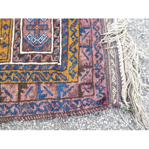 222 - Four dissimilar rugs: to include a Turkoman, on a red ground  34