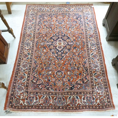 227 - A Persian rug, profusely decorated with floral designs, on a mainly red ground  53