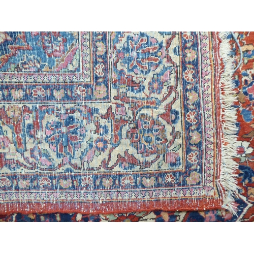 227 - A Persian rug, profusely decorated with floral designs, on a mainly red ground  53