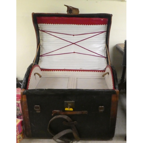 241 - An early 20thC hide bound canvas cabin trunk with a domed lid and straight sides and a removable tra... 