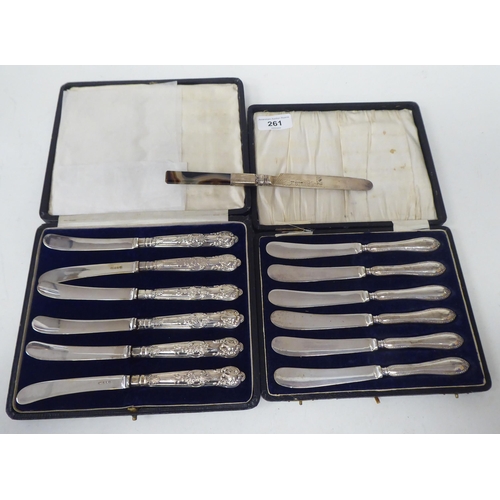 261 - Two sets of six loaded silver handled butter knives  both boxed; and one single  mixed mar... 