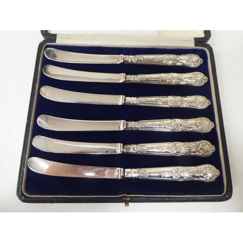 261 - Two sets of six loaded silver handled butter knives  both boxed; and one single  mixed mar... 