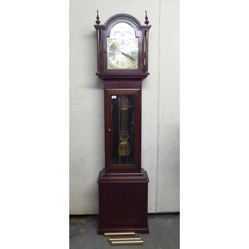 323 - A 20thC West German mahogany finished longcase clock; the chiming chain driven movement faced by a R... 