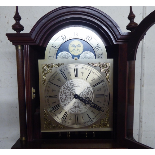 323 - A 20thC West German mahogany finished longcase clock; the chiming chain driven movement faced by a R... 