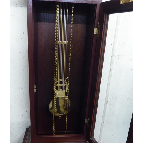 323 - A 20thC West German mahogany finished longcase clock; the chiming chain driven movement faced by a R... 