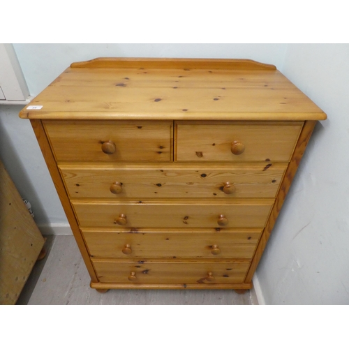 34 - A modern pine six drawer dressing chest, on a plinth and bun feet  42