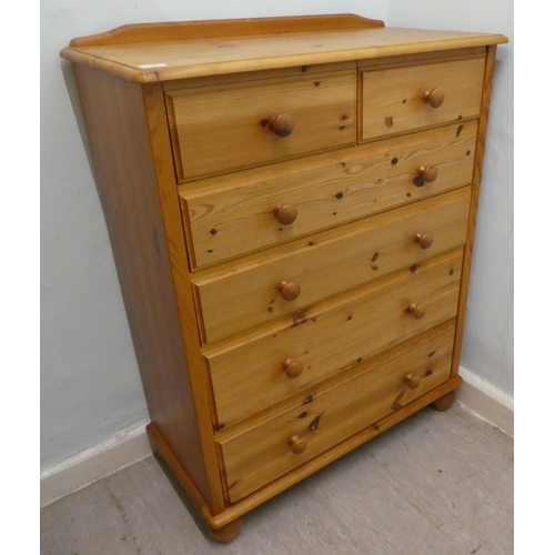 34 - A modern pine six drawer dressing chest, on a plinth and bun feet  42