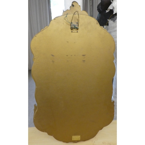 69 - A modern mirror, the shaped plate in a moulded gilt frame  30