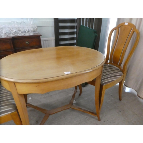 93 - A 20thC bleached wood oval centre table, raised on splayed legs  29