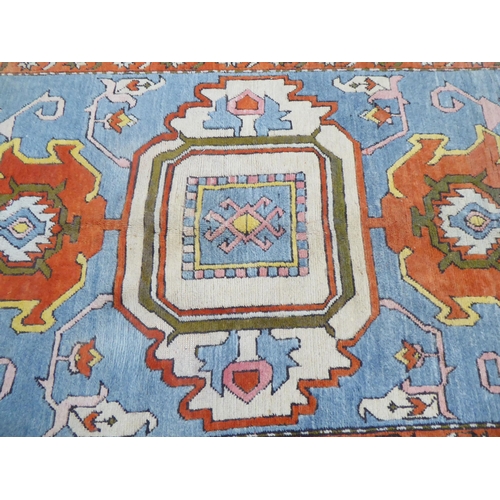 96 - A Turkish Azari style rug, decorated in bright colours with stylised designs  69